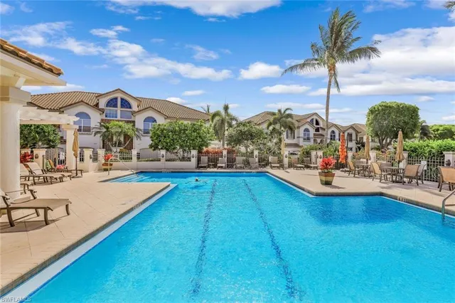 a view of multiple houses with swimming pool