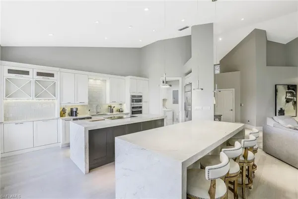 a kitchen with a stove a refrigerator and a dining table