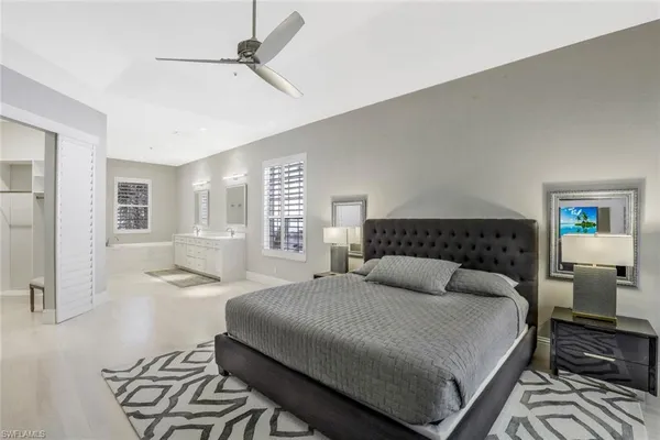a bedroom with a large bed and a window