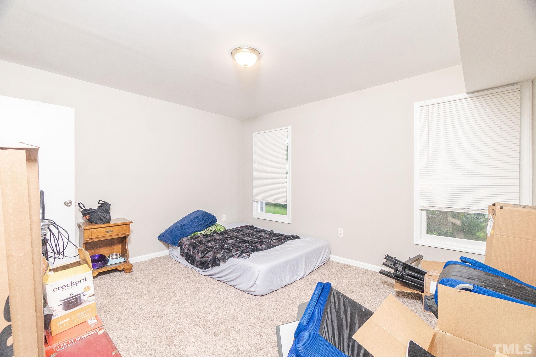 133 Bashford Road Raleigh, NC 27606 - Photo 13 of 45 a living room with a couch and a table with wooden floor