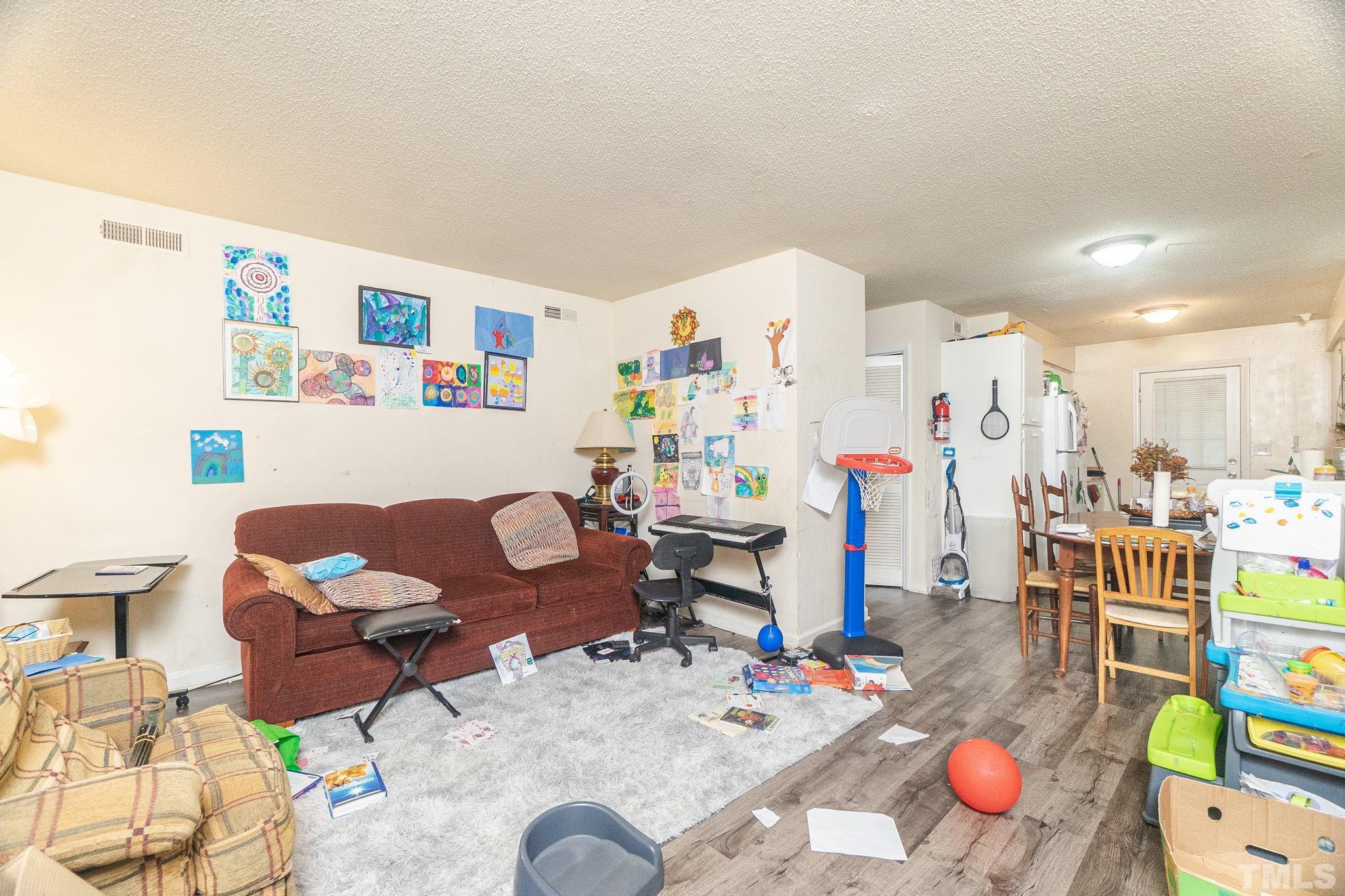 133 Bashford Road Raleigh, NC 27606 - Photo 17 of 45 a living room with furniture kitchen appliances and a dining table