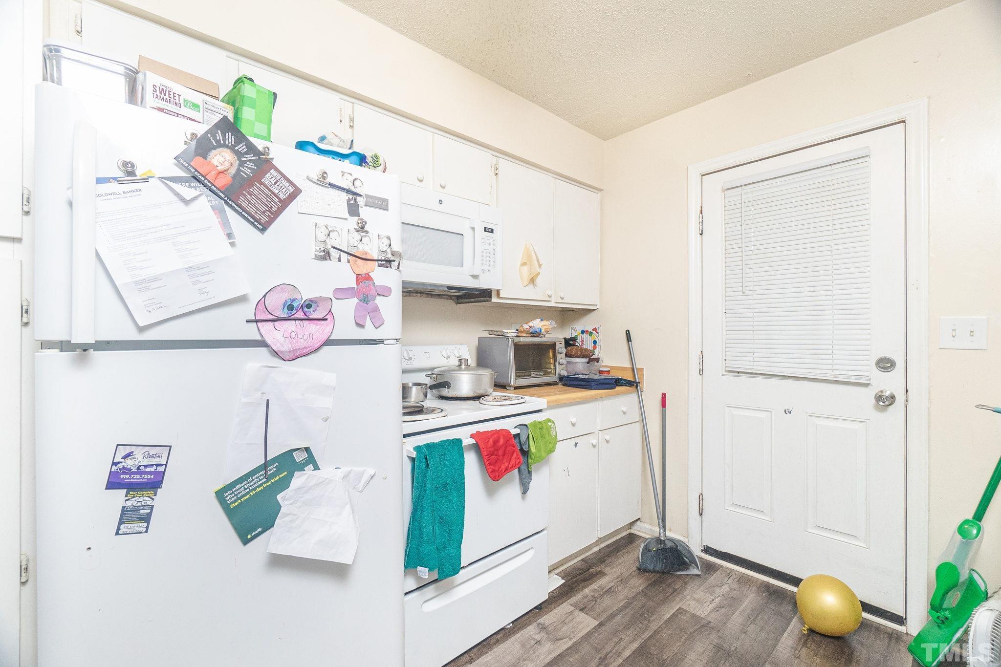 133 Bashford Road Raleigh, NC 27606 - Photo 19 of 45 a kitchen with a refrigerator and a stove