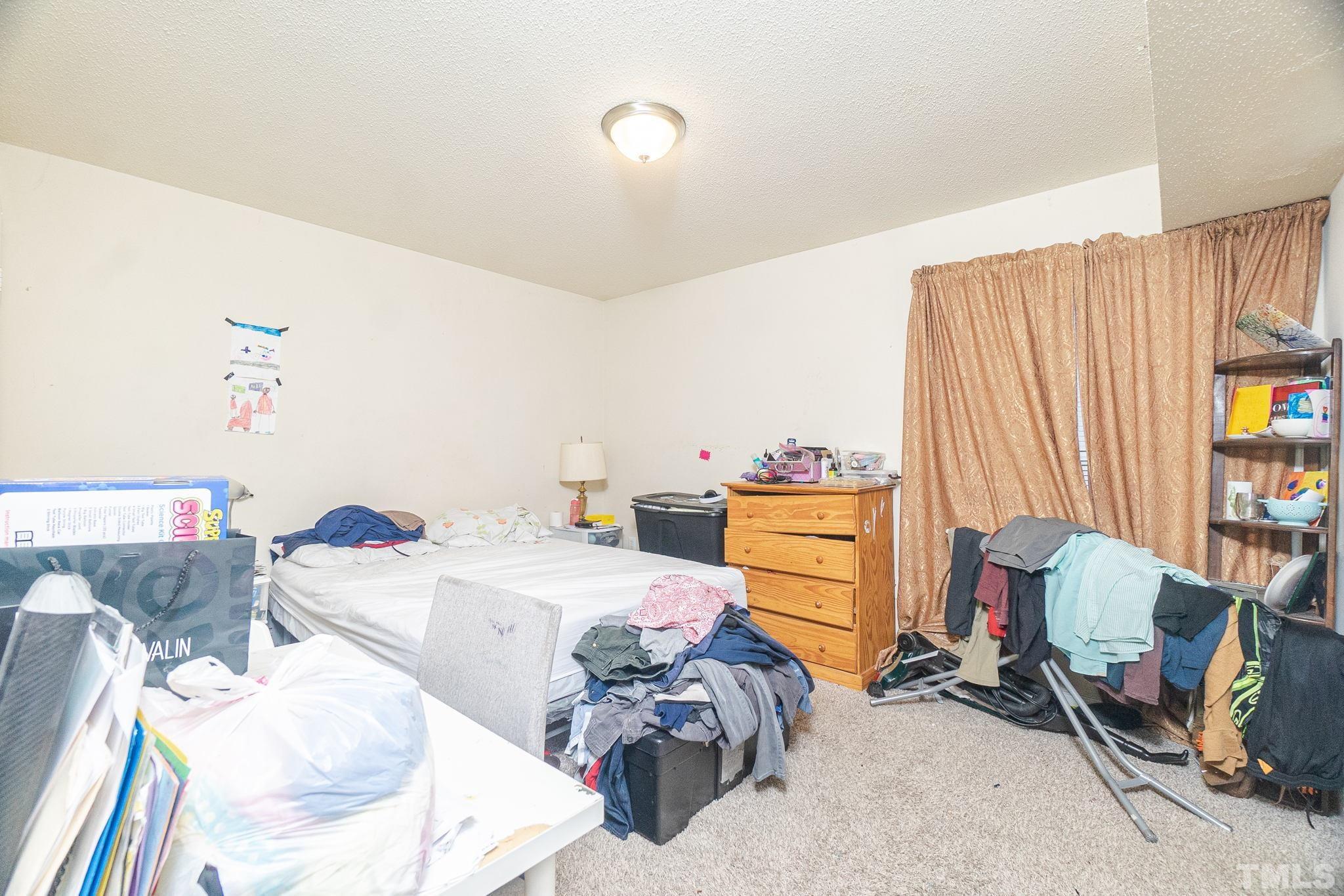 133 Bashford Road Raleigh, NC 27606 - Photo 20 of 45 a bed room with a bed and a chair