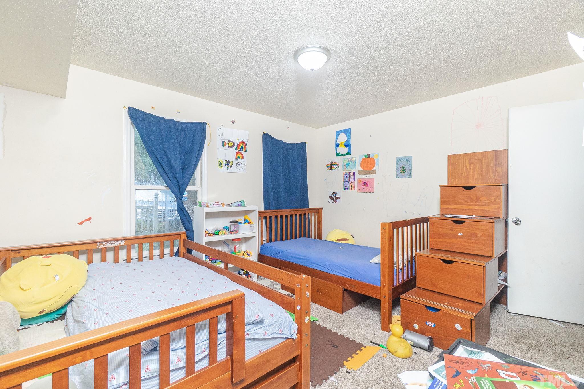 133 Bashford Road Raleigh, NC 27606 - Photo 22 of 45 a bedroom with furniture and a wooden floor
