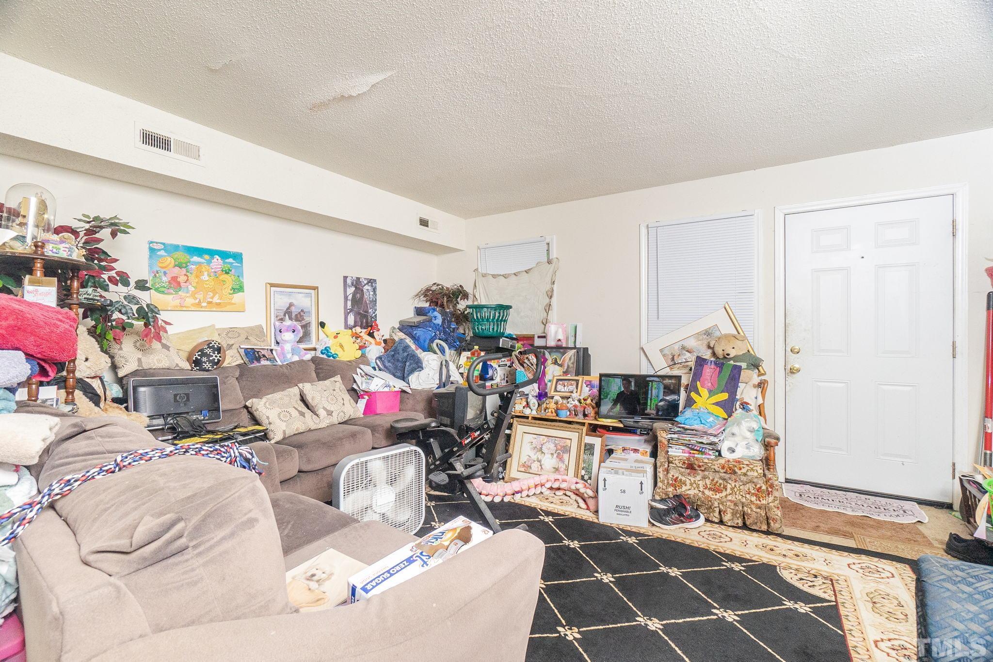 133 Bashford Road Raleigh, NC 27606 - Photo 25 of 45 a living room with lots of furniture and toys
