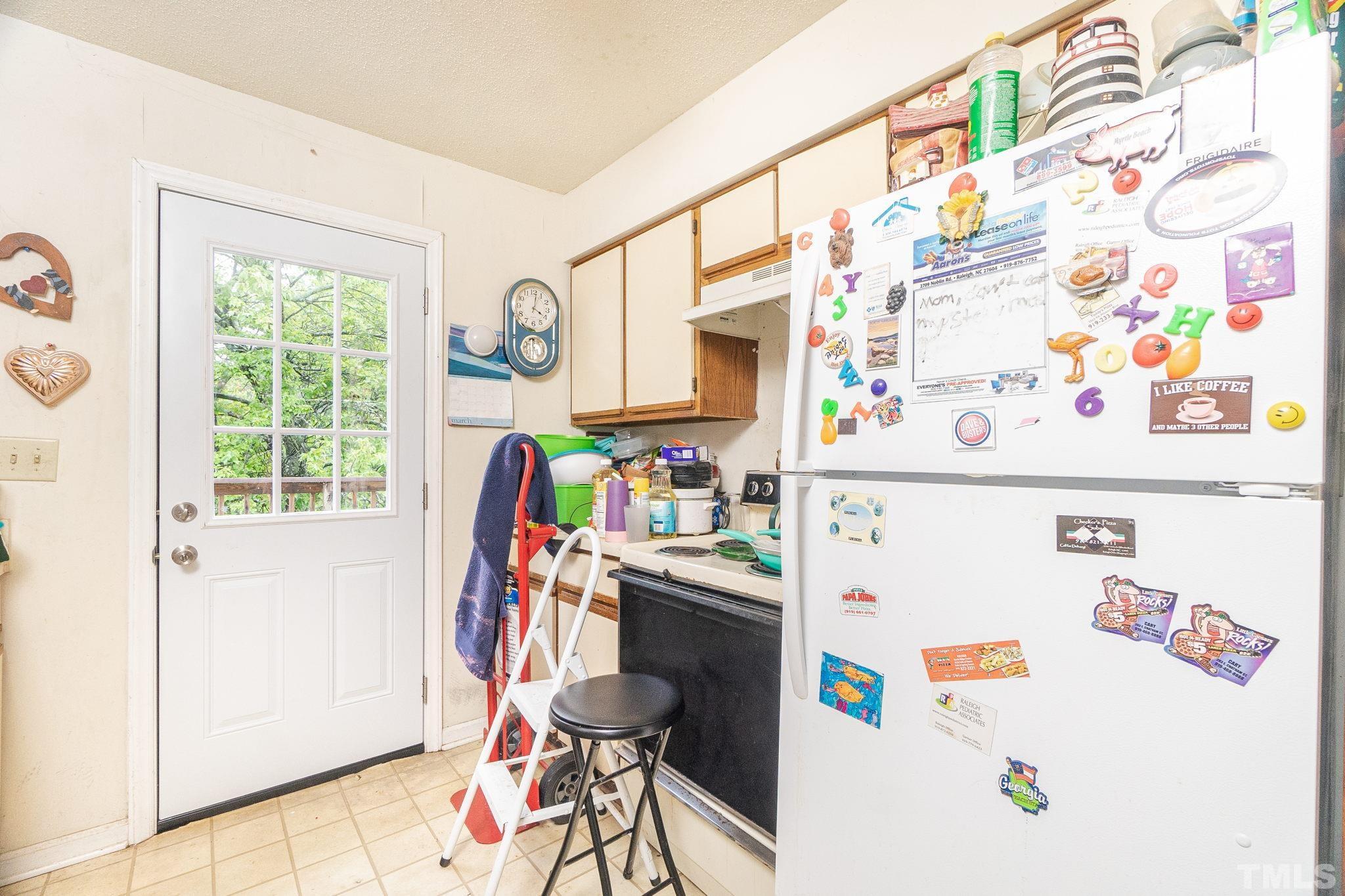 133 Bashford Road Raleigh, NC 27606 - Photo 28 of 45 a utility room with fridge dryer and a couch