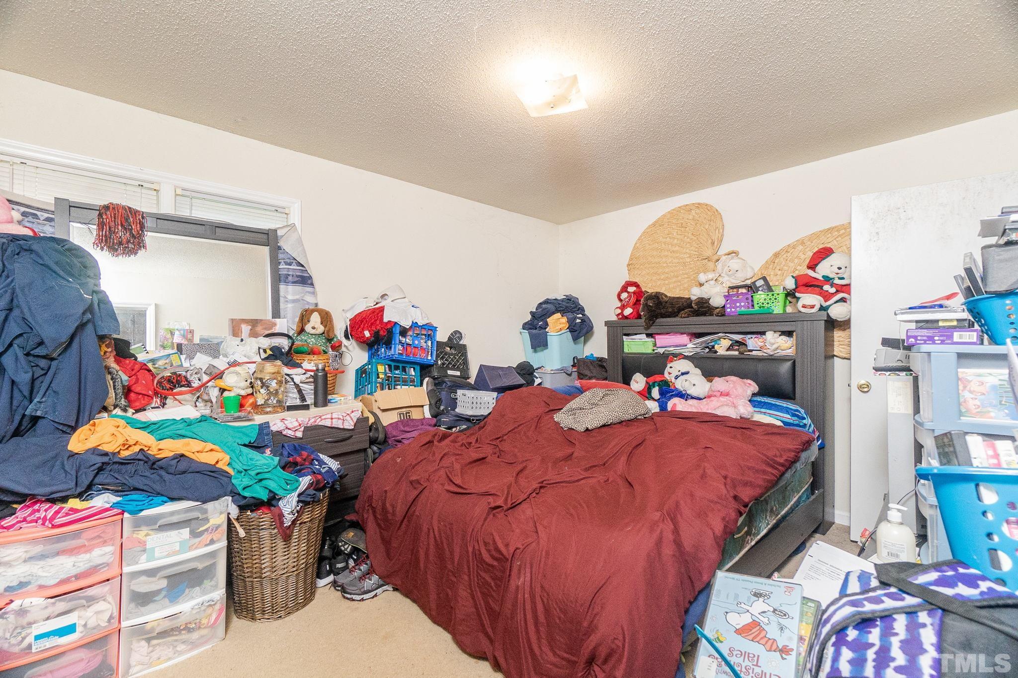 133 Bashford Road Raleigh, NC 27606 - Photo 29 of 45 a bedroom with bed and a chandelier