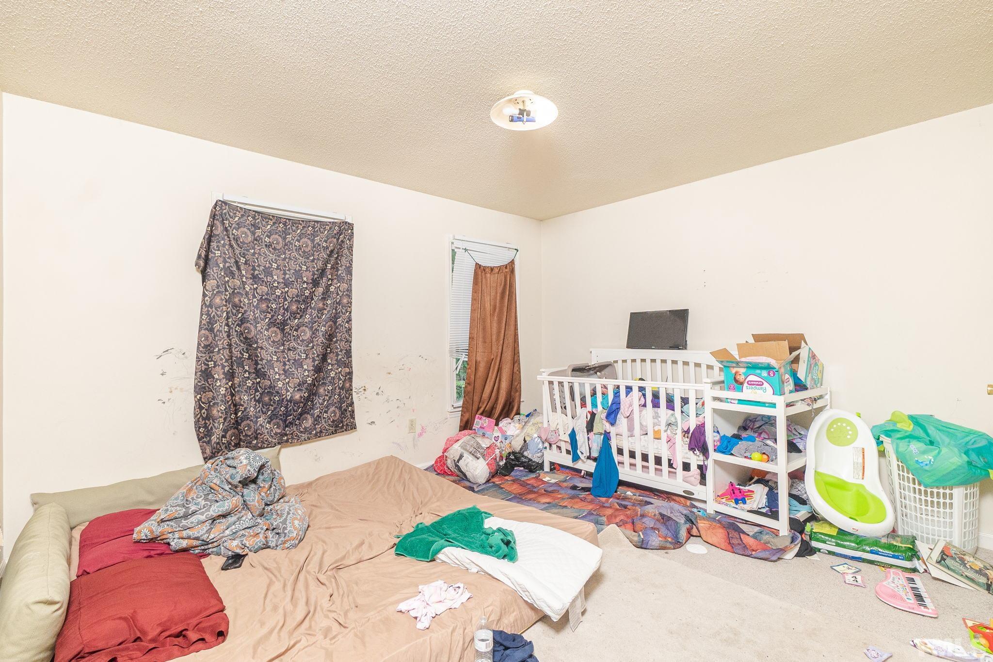 133 Bashford Road Raleigh, NC 27606 - Photo 38 of 45 a bedroom with a bed and a couch