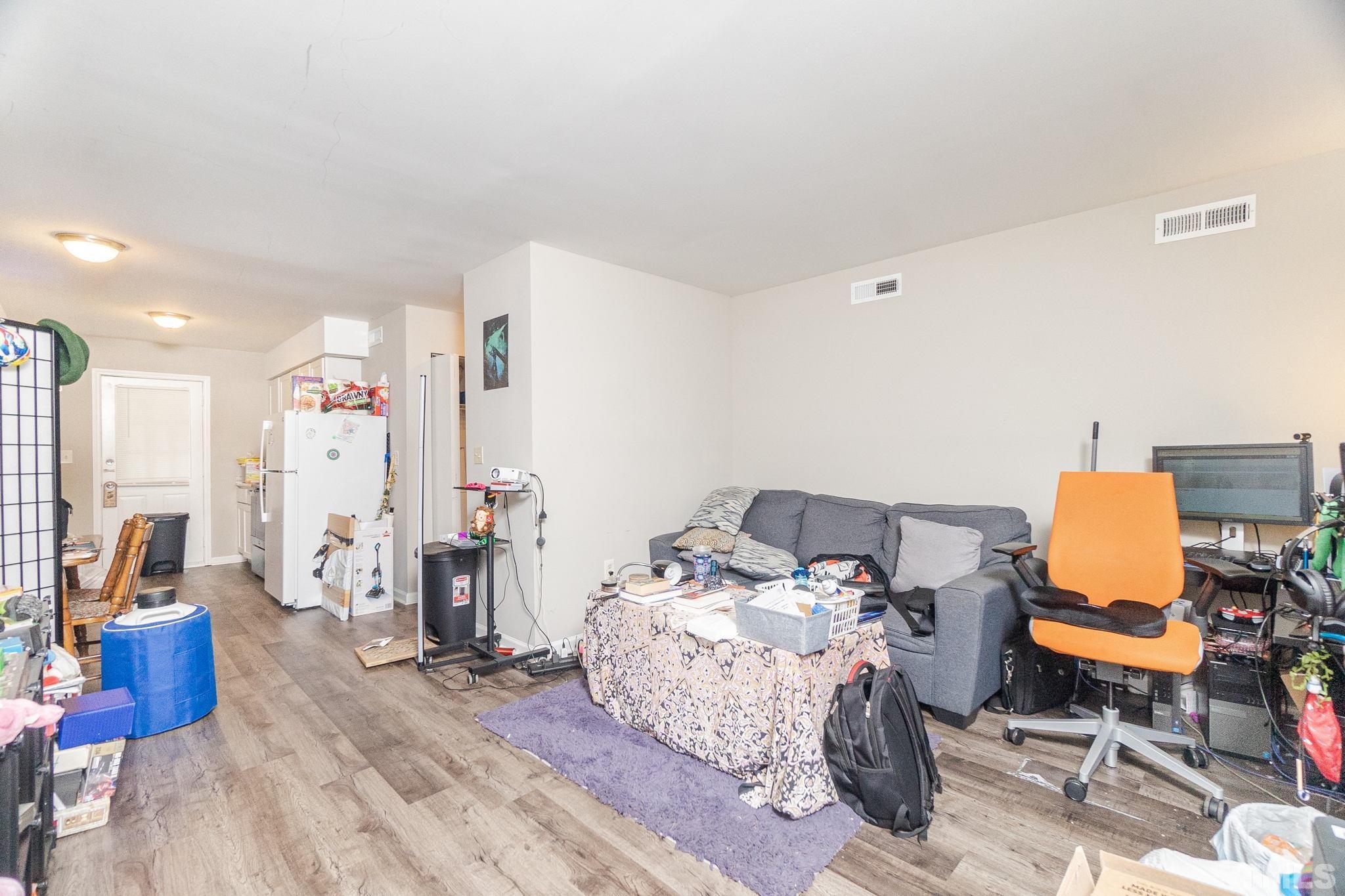 133 Bashford Road Raleigh, NC 27606 - Photo 8 of 45 a bedroom with furniture and a wooden floor