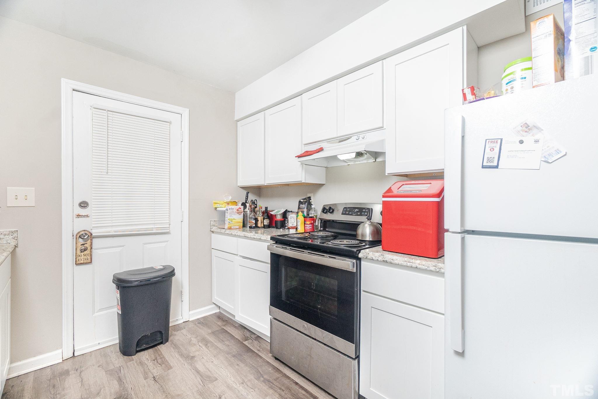 133 Bashford Road Raleigh, NC 27606 - Photo 10 of 45 a kitchen with a white stove top oven and refrigerator
