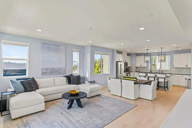 a living room with lots of furniture and kitchen view