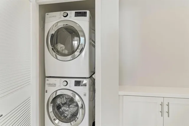 a view of a hallway with washer and dryer