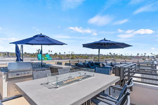 a view of a patio with furniture and a backyard