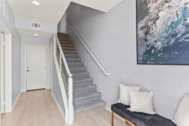a view of entryway and hall with wooden floor