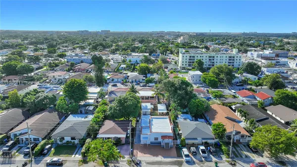 an aerial view of residential houses with outdoor space and street view
