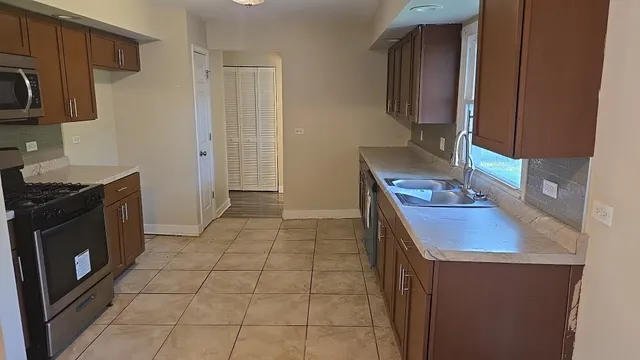 a kitchen with a sink stove and cabinets