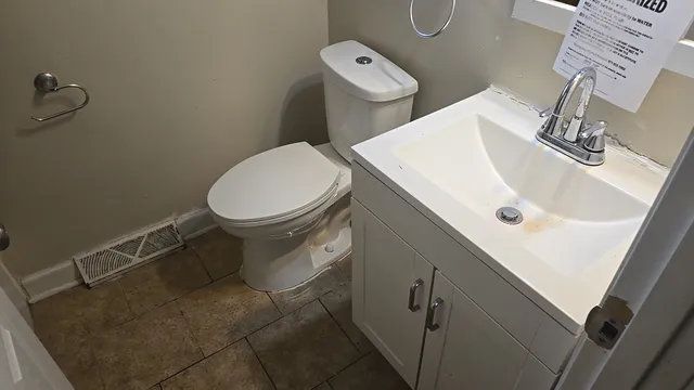 a white toilet sitting next to a bathroom sink
