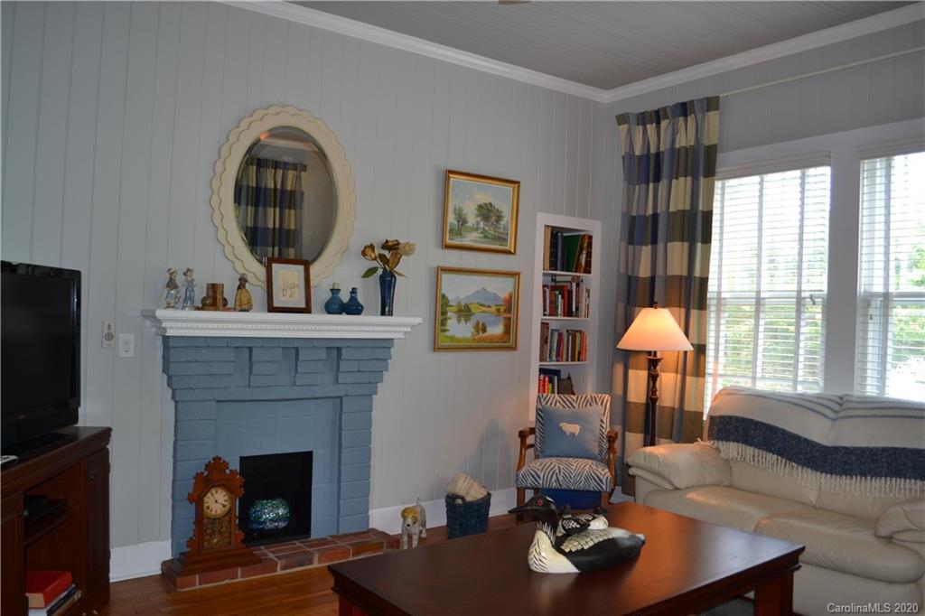 222 Maple Street Rutherfordton, NC 28139 - Photo 25 of 48 a living room with furniture a flat screen tv and a fireplace