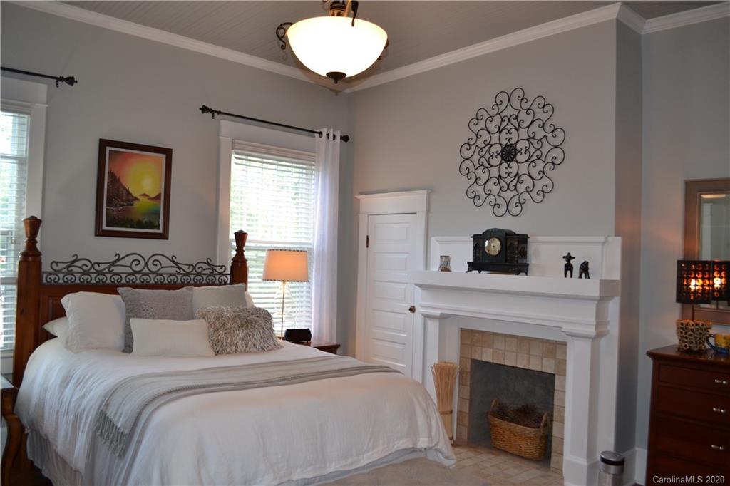 222 Maple Street Rutherfordton, NC 28139 - Photo 26 of 48 a bedroom with a bed and a fireplace