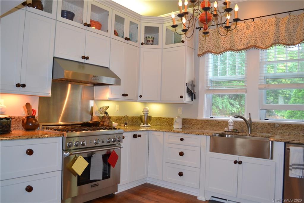 222 Maple Street Rutherfordton, NC 28139 - Photo 36 of 48 a kitchen with stainless steel appliances granite countertop a sink stove and cabinets