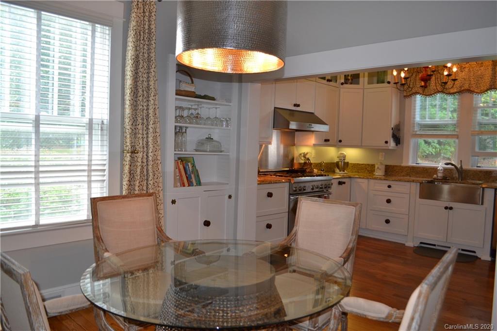 222 Maple Street Rutherfordton, NC 28139 - Photo 39 of 48 a kitchen with stainless steel appliances granite countertop a table chairs and a living room