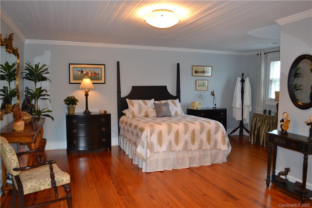 222 Maple Street Rutherfordton, NC 28139 - Photo 45 of 48 a bedroom with a bed and wooden floor