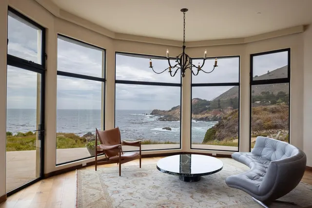 a living room with hardwood floor and a large window