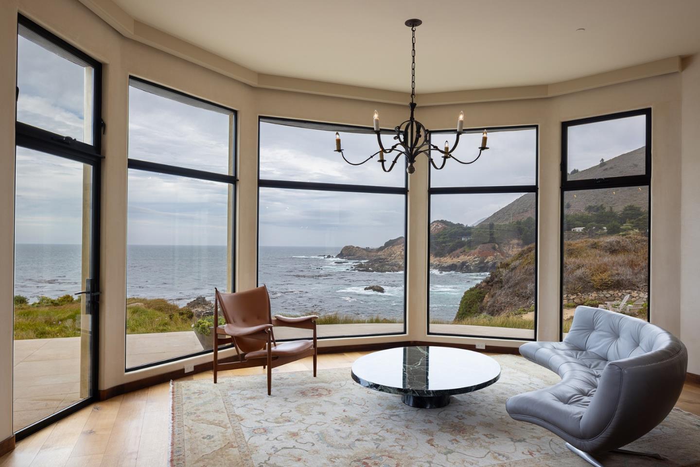 36654 Highway 1 Carmel, CA 93923 - Photo 7 of 23 a living room with hardwood floor and a large window