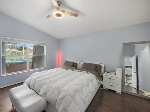 a bedroom with a bed and a large window