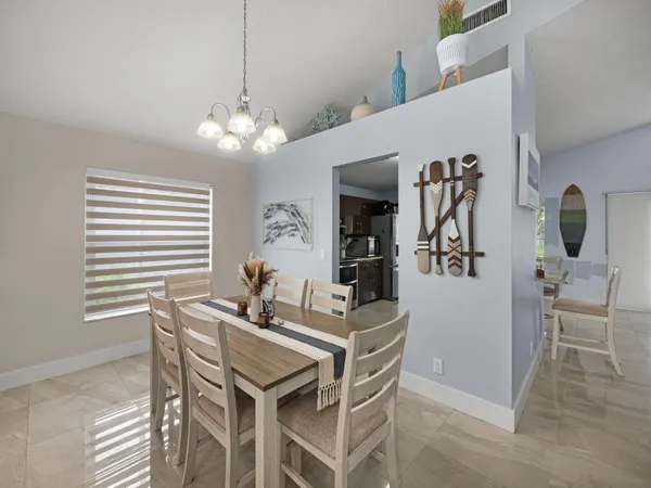 a dining room with furniture and window