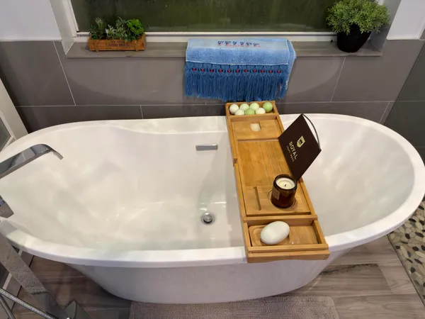 a bathroom with a bathtub and mirror
