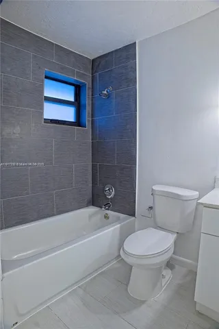 a bathroom with a toilet and a bath tub