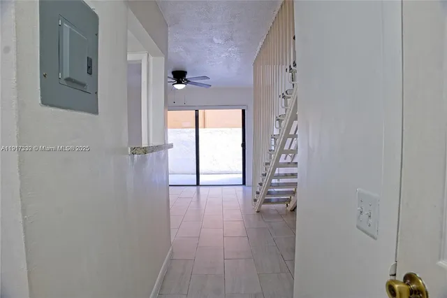 a view of a hallway with wooden floor and entryway