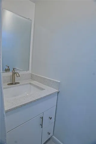 a bathroom with a sink and vanity