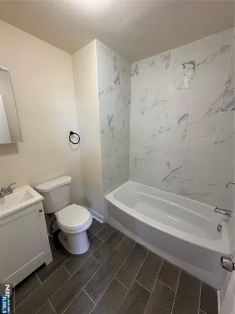 a bathroom with a toilet a sink and a shower