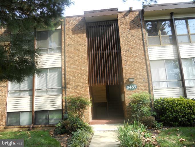 8489 Greenbelt Road, Unit 202 Greenbelt, MD 20770 - Photo 1 of 10 a front view of a house with a yard