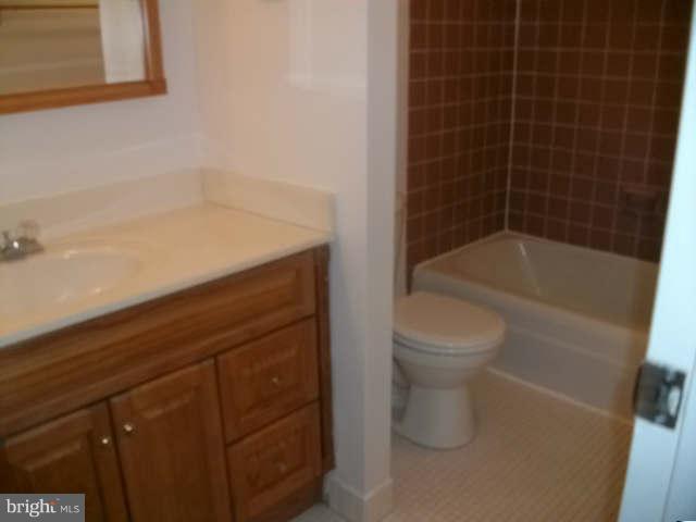 8489 Greenbelt Road, Unit 202 Greenbelt, MD 20770 - Photo 2 of 10 a bathroom with a bathtub and a toilet