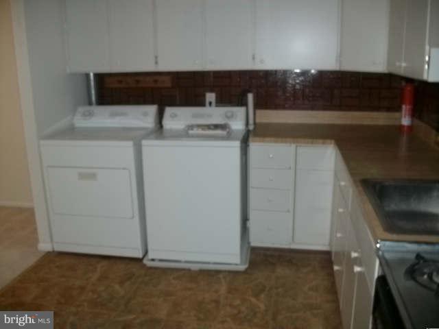 8489 Greenbelt Road, Unit 202 Greenbelt, MD 20770 - Photo 3 of 10 a kitchen with a sink and cabinets