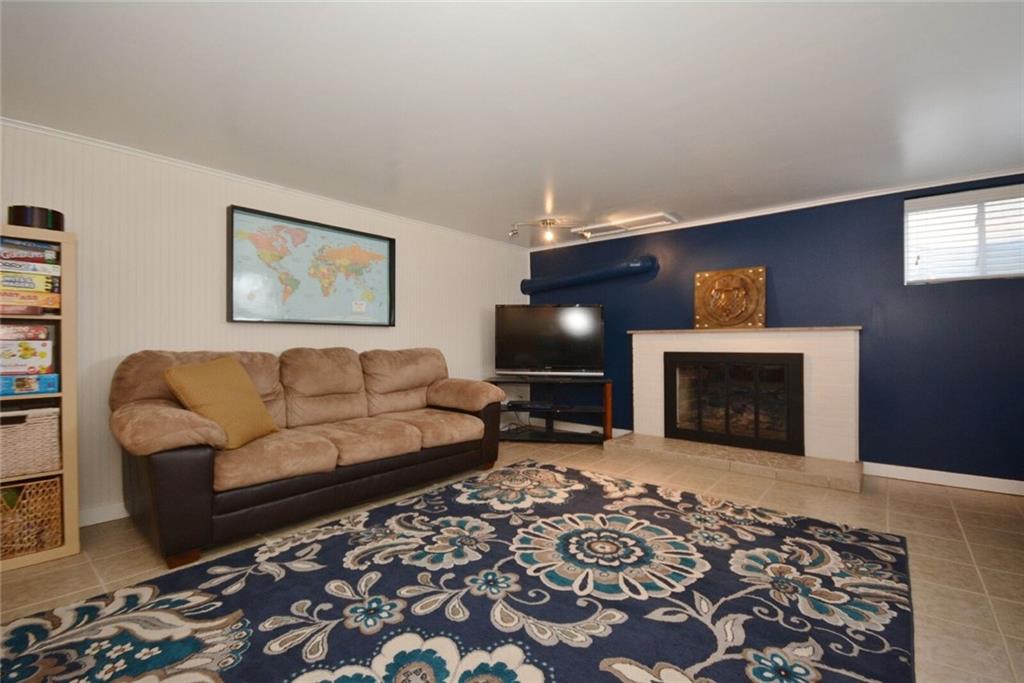 2428 Rose Garden Road Pittsburgh, PA 15220 - Photo 20 of 25 HUGE game room with bead board walls, ceramic tiled floor and decorative fireplace.