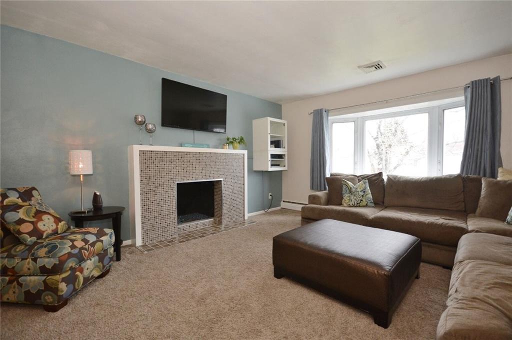 2428 Rose Garden Road Pittsburgh, PA 15220 - Photo 6 of 25 The glass mosaic tiled, ventless gas fireplace gives the living room a warm cozy feel.