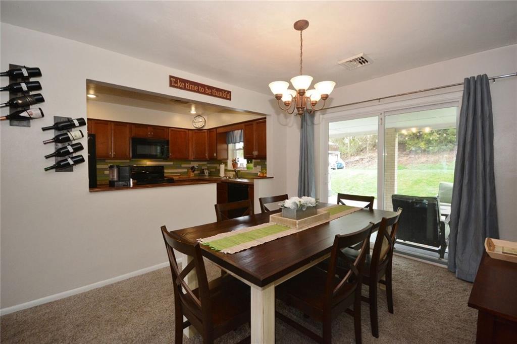 2428 Rose Garden Road Pittsburgh, PA 15220 - Photo 9 of 25 Large Dining Room with pass through/door way into kitchen gives you the perfect space for entertaining. Sliding doors leading out onto the covered patio gives you even more living space.