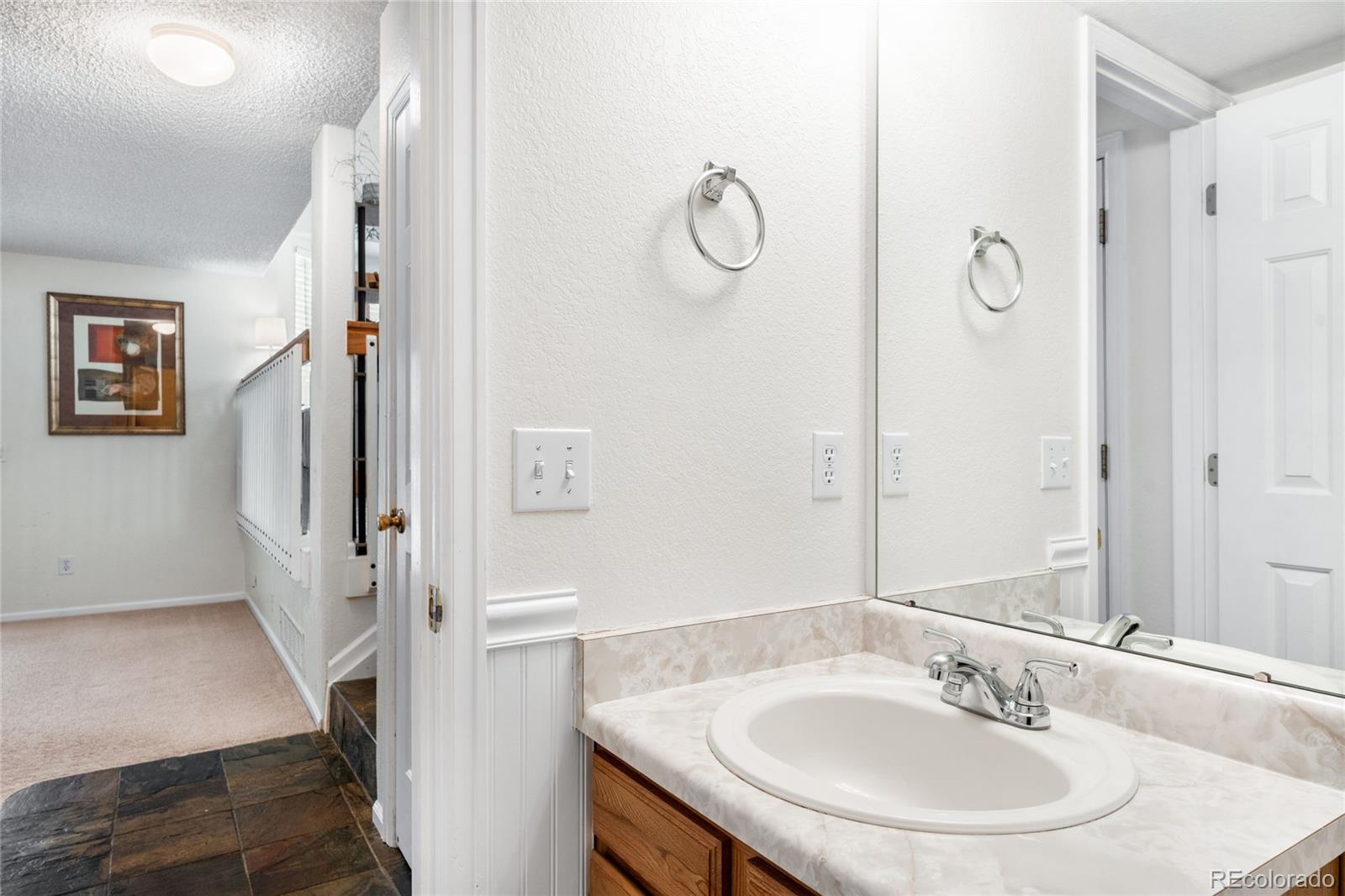 4132 South Jebel Way Aurora, CO 80013 - Photo 15 of 36 a bathroom with a sink and a mirror