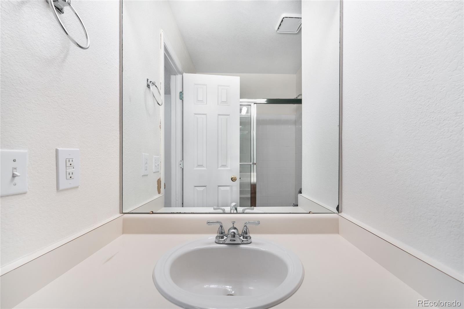 4132 South Jebel Way Aurora, CO 80013 - Photo 24 of 36 a bathroom with a sink and a mirror