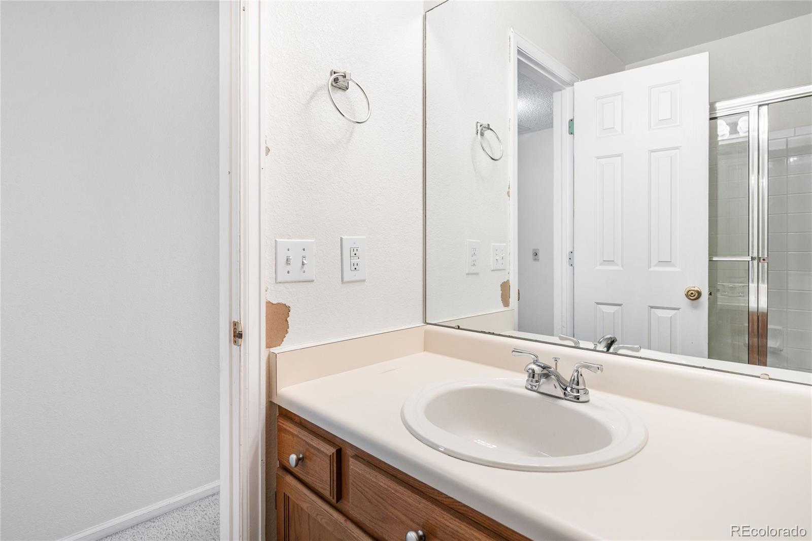 4132 South Jebel Way Aurora, CO 80013 - Photo 25 of 36 a bathroom with a granite countertop sink and a mirror
