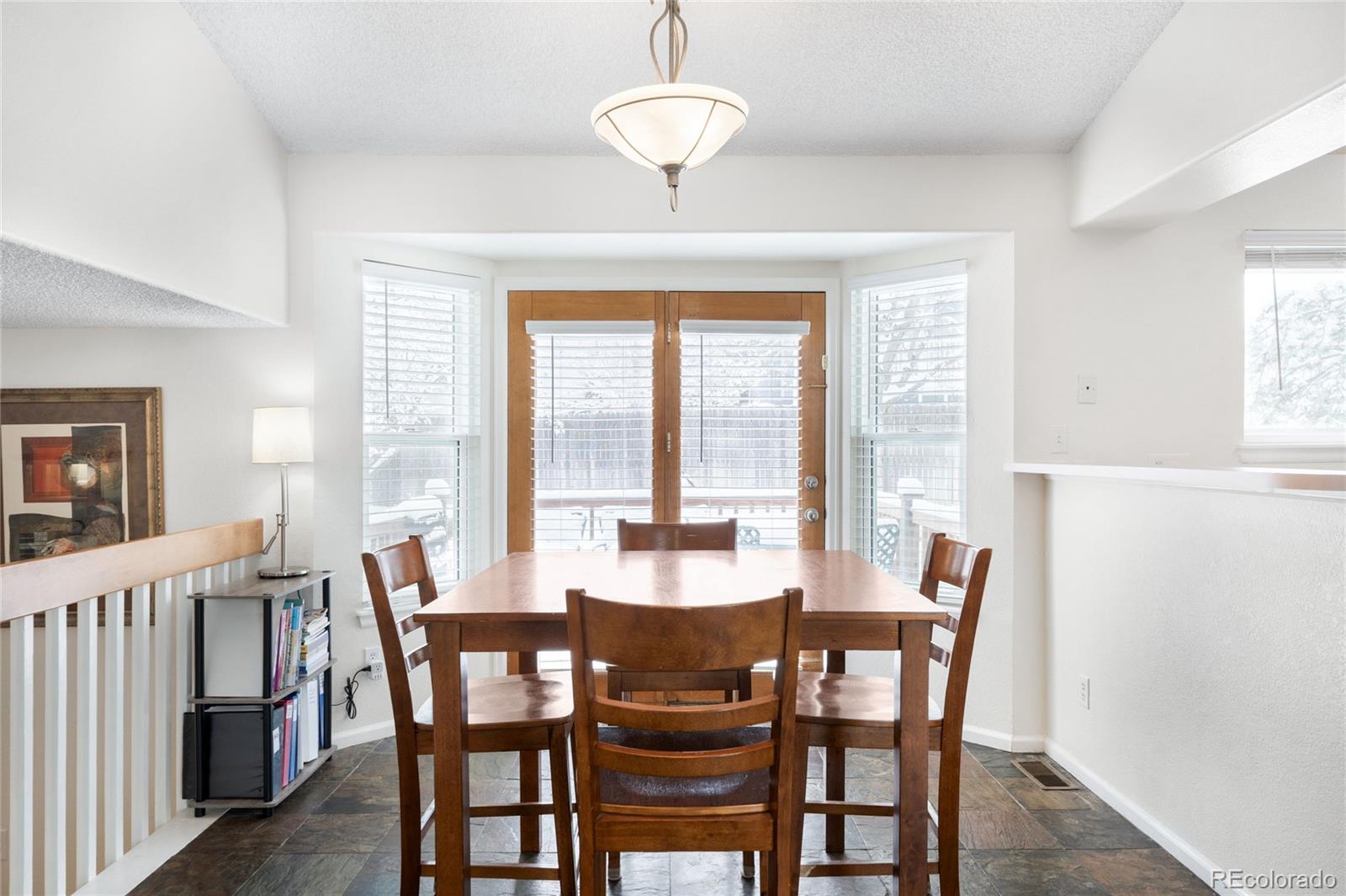 4132 South Jebel Way Aurora, CO 80013 - Photo 5 of 36 a view of a dining room with furniture window and outside view