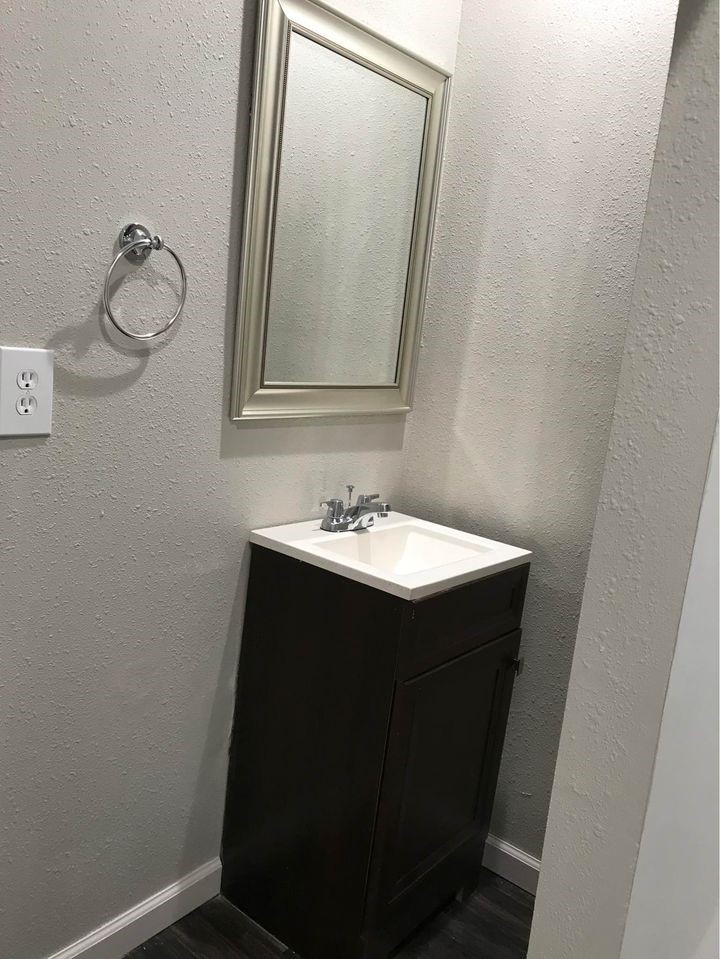 1020 North Main Street, Unit 9 Baytown, TX 77520 - Photo 7 of 8 a bathroom with a sink vanity and mirror