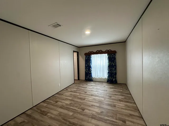 a view of hallway with wooden floor