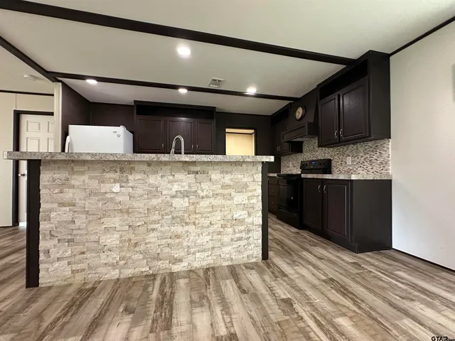 a view of kitchen cabinets and wooden floor