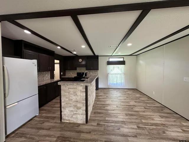 a kitchen with refrigerator and window