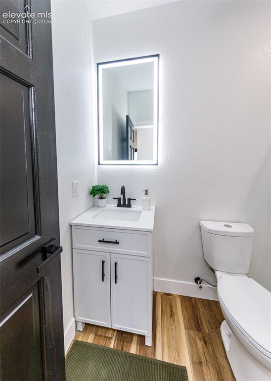 1120 Newton Road Pueblo, CO 81005 - Photo 20 of 46 a bathroom with a sink vanity granite toilet and a mirror